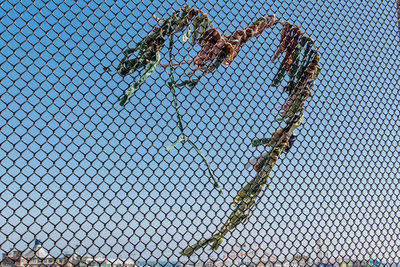 Low angle view of chainlink fence against clear sky