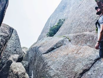 Midsection of rock formation against sky