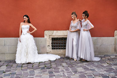 Rear view of couple standing against wall