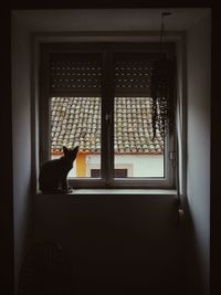 Silhouette of woman sitting at home