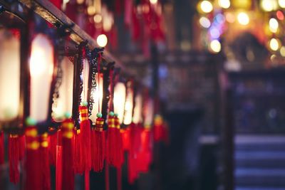 Close-up of illuminated lanterns hanging at night