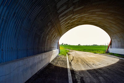 Road amidst tunnel against sky