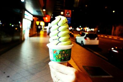 Close-up of hand holding ice cream cone