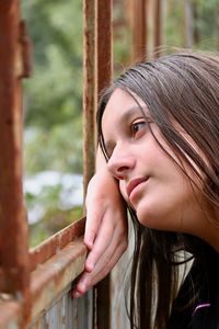 Close-up portrait of young woman looking away