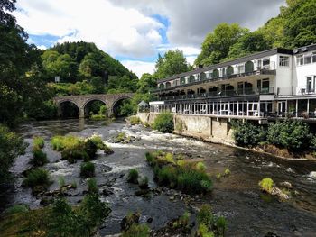Arch bridge over river against sky