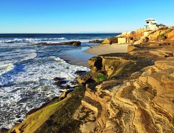 Scenic view of sea seen from cliff against sky