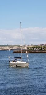 Sailboat on sea against sky