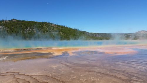 Scenic view of landscape against blue sky