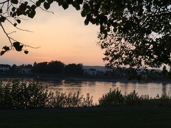 Scenic view of lake against sky at sunset