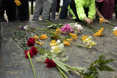 Laying flowers on tombstone. flowers at ceremony. grave of inexhaustible soldier in russia. 