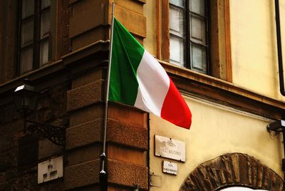 Low angle view of italian flag against building