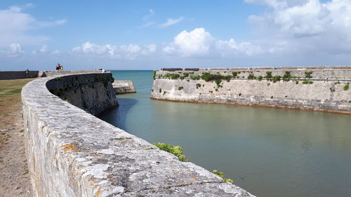 Scenic view of sea and ramparts against sky