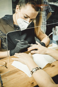 Midsection of woman sitting on table