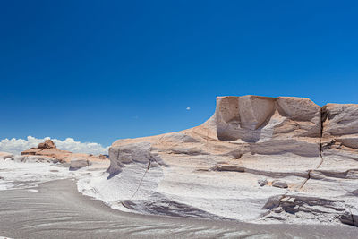 Scenic view of desert against clear blue sky