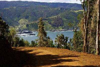 Scenic view of lake by mountains against sky