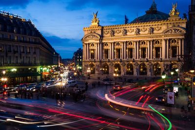 Light trails by opera garnier in city at night