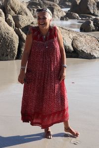 Portrait of smiling young woman standing on rock