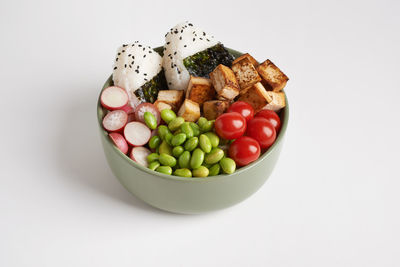 Vegan bowl with onigiri, tofu and vegetables