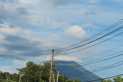 Low angle view of electricity pylon against sky