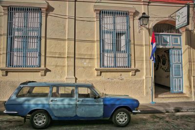 Vintage car on street against building