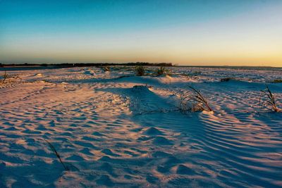 Scenic view of sea against clear sky during sunset