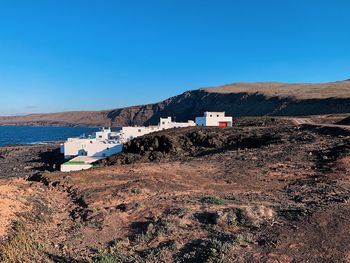 Scenic view of mountains against clear blue sky