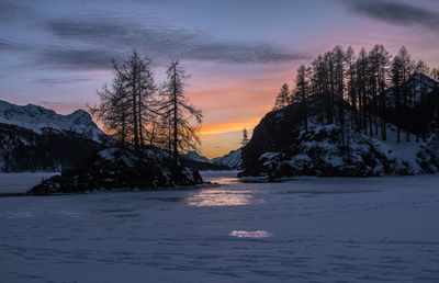 Scenic view of snowcapped mountains against sky during sunset