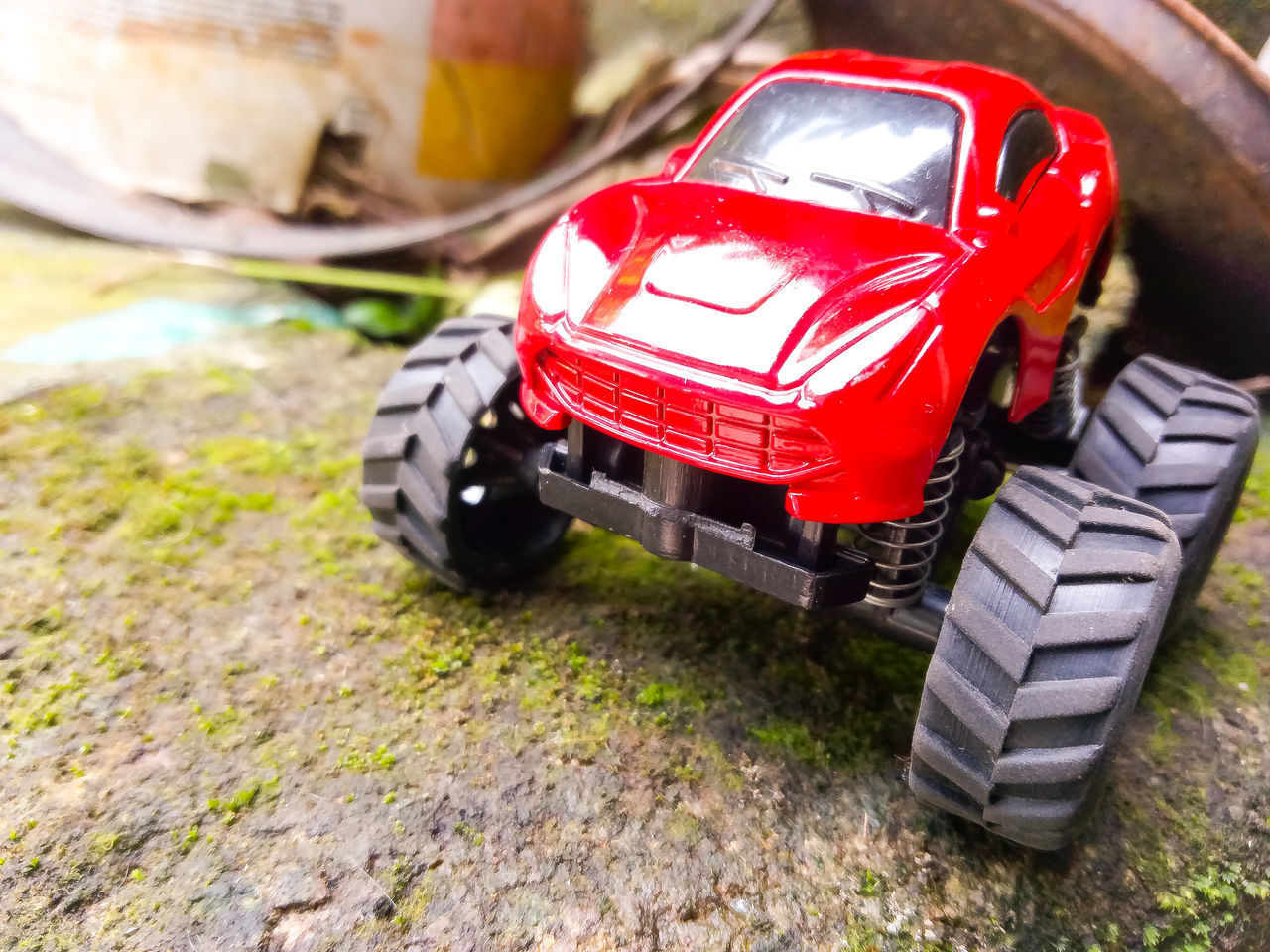 CLOSE-UP OF TOY CAR ON ROCKS
