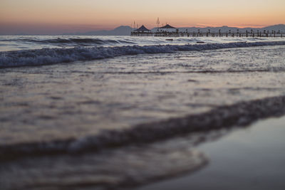 Scenic view of beach against sky during sunset