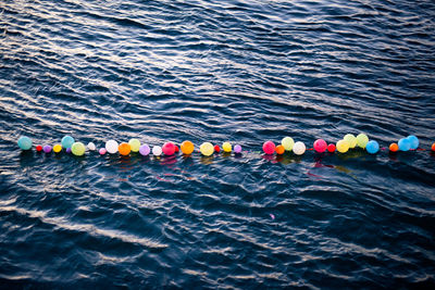 High angle view of colorful balloons floating on sea