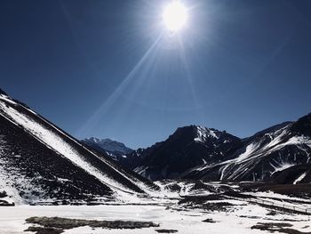 Snow covered mountain against sky on sunny day