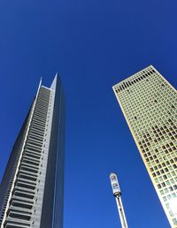 Low angle view of modern buildings against clear blue sky