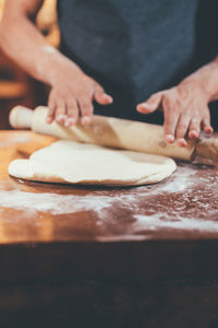 Midsection of person preparing food at table