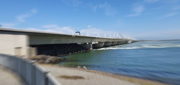 Pier over sea against blue sky
