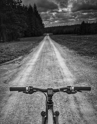 Empty road on field against sky