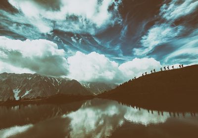 Panoramic view of lake and mountains against sky