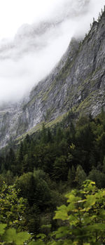 Scenic view of mountain range against cloudy sky