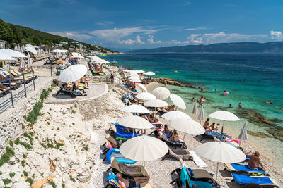 High angle view of people at beach against sky