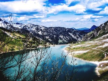 Scenic view of lake against cloudy sky