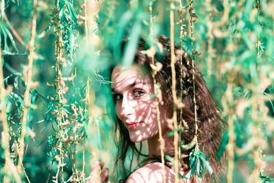 Portrait of young woman lying on land