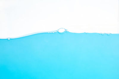 Close-up of bubbles against blue background