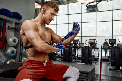 Side view of man exercising in gym