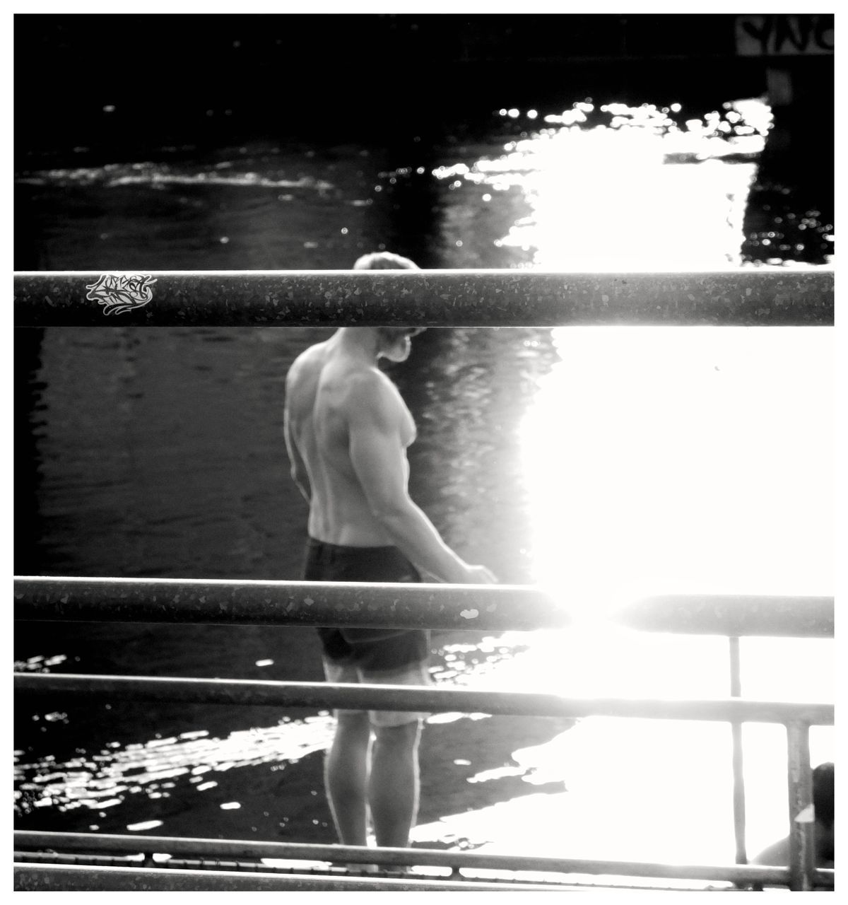 black and white, one person, monochrome photography, swimming, full length, lifestyles, adult, sunlight, nature, monochrome, day, transfer print, water, auto post production filter, women, young adult, rear view, leisure activity, outdoors, person, standing, swimming pool