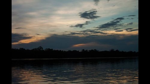 Scenic view of lake against cloudy sky