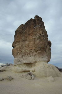 Low angle view of rock formations against sky