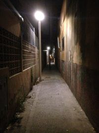 Illuminated walkway at night