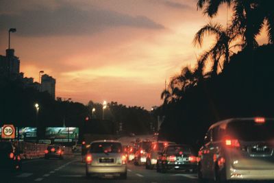 Traffic on city street during sunset