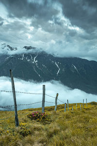 Scenic view of field in the mountains against sky