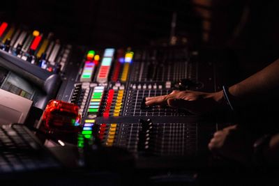 Cropped hand of musician adjusting audio equipment