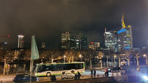 Illuminated buildings in city against sky at night